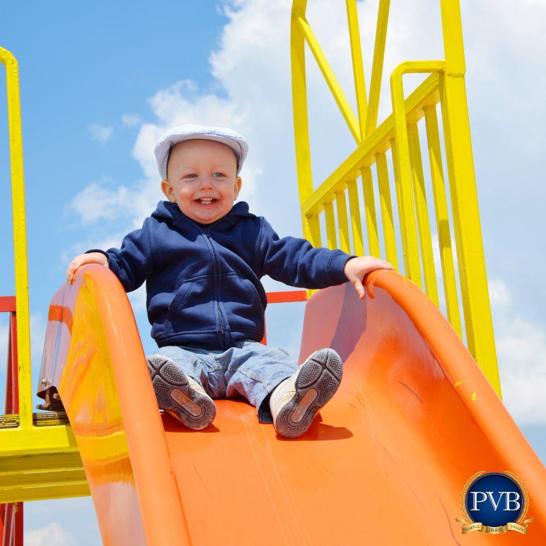 photo of a baby on a slide